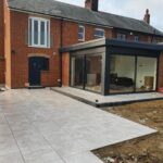 Modern patio with glass extension.