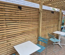 Wooden slatted wall with tables