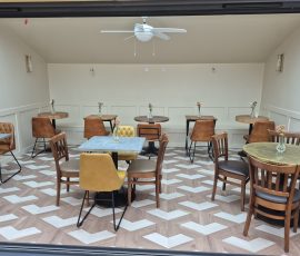 Empty café with wooden tables and chairs