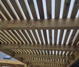 Wooden pergola with slatted roof