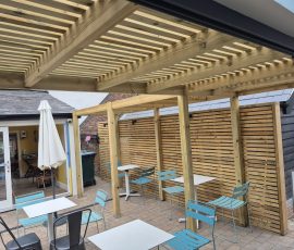 Outdoor seating area with wooden pergola