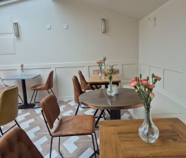 Cozy cafe with floral table arrangements