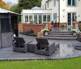 Outdoor patio with seating and greenery.